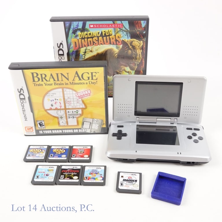 Nintendo DS System & 9 Games: Silver Nintendo DS System. Tested and working per consigner. Lot includes 9 games: "Digging For Dinosaurs" (with original box and booklet), "Brain Age" (with original box and booklet), "Zoo Tycoon DS"