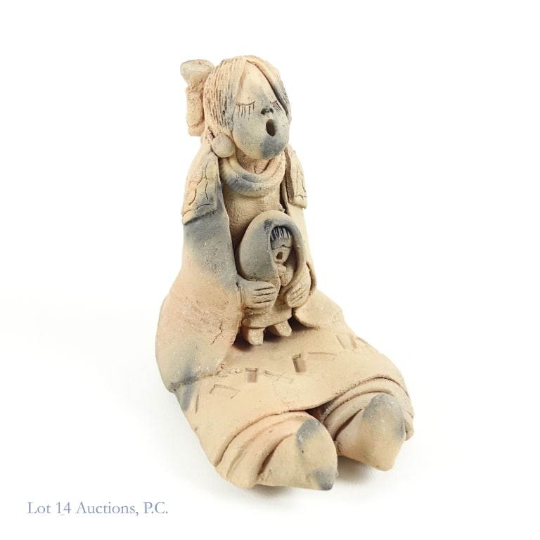 Taos Pueblo Storyteller Figure (M. Quintana?): Traditional storyteller figurine made with micaceous clay by a Taos Puebloan artist - possibly Margaret Quintana - depicting an older woman holding a child. It is signed by the artist on the bottom. A