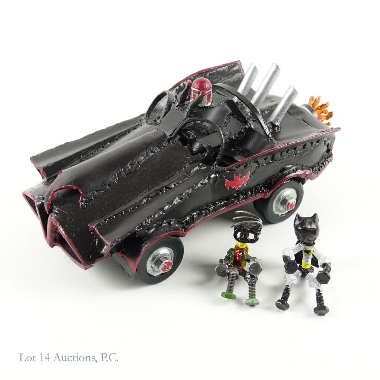 Rob Nehring Batmobile Metal Sculpture Rusty Noodle: Batmobile upcycled metal sculpture by Rob Nehring / Rusty Noodle Studios. Fully painted. All 4 wheels turn. Approximately 13.5" x 7" x 6", 11lbs. Includes removable Batman and Robin sculptures, in sit