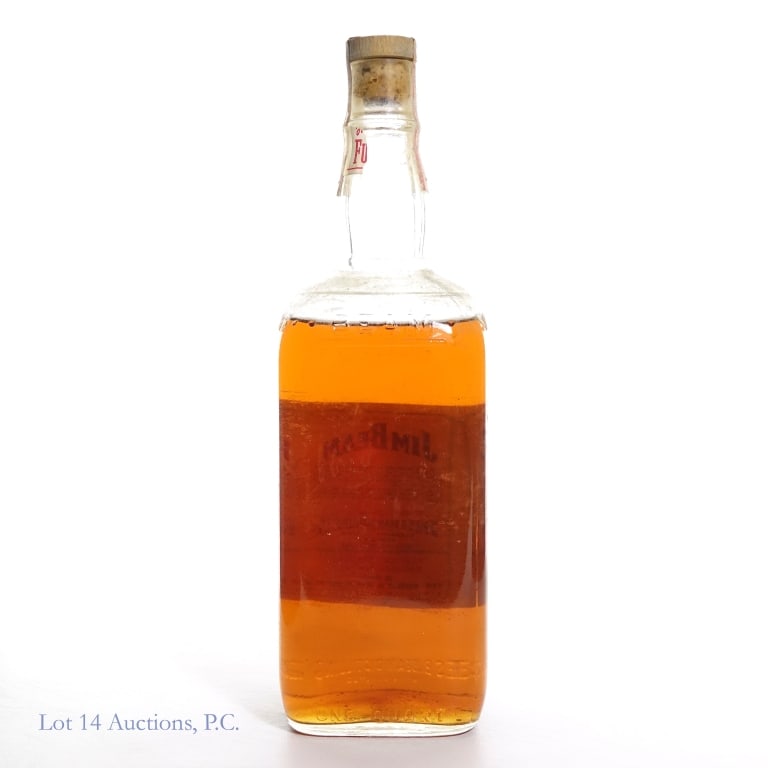 1960s/1970s Jim Beam 4 Year Bourbon: Jim Beam 4 Year Bourbon, 86 Proof, 4/5 Quart, early 1960s-late 1970s tax strip. Neck label disintegrated, tax strip intact, front label missing. Fill at shoulder. Sedimentation at the bottom.