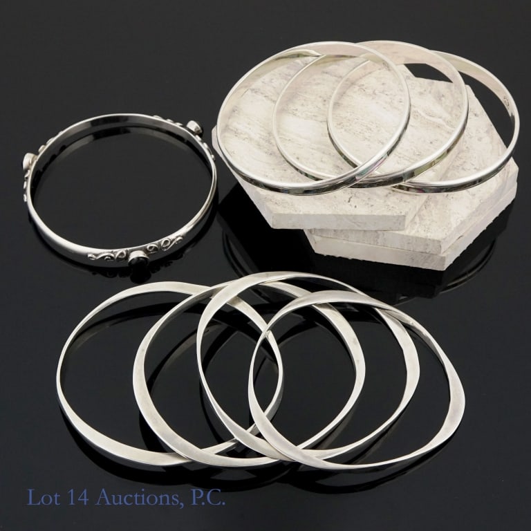 Sterling Silver Bangle Bracelets (8): Sterling silver bangle bracelets. Four of these are one set. Another three are one set. The seventh is a singleton. All pieces are marked "sterling", "925", or equivalent. Total weight: 112.5 grams.