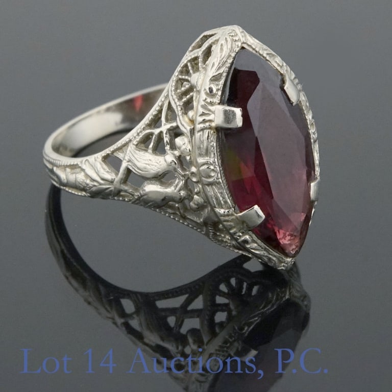 14K W Gold Garnet / Rubellite Filigree Ring: White gold filigree ring marked "14K" and tests electronically as 14 karat gold. Stone tests electronically as either garnet or rubellite. Size 6. Total weight: 2.9 grams.