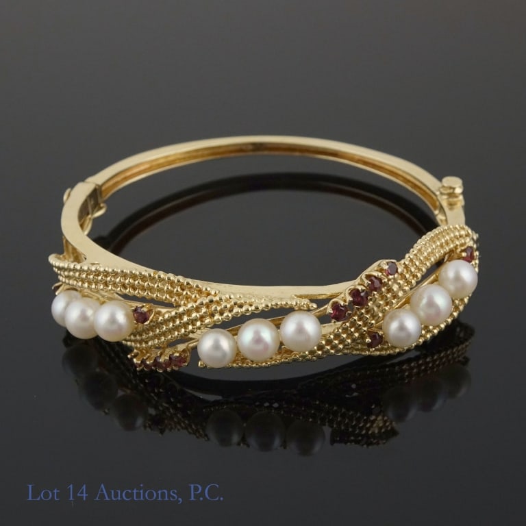 14K Y Gold Garnet Pearl (?) Cuff Bracelet: Yellow gold cuff bracelet with box clasp. Marked "14k" and tests electronically as 14 karat gold. Small red stones test electronically as garnet. The white stones could not be tested. Inner diameter a