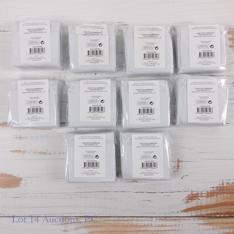 Box of Dior Star Bag Charms (100 total): Box containing ten packages of bag charms, each containing ten Dior star charms. Charms are still in tissue paper and plastic packaging and appear to be untouched.