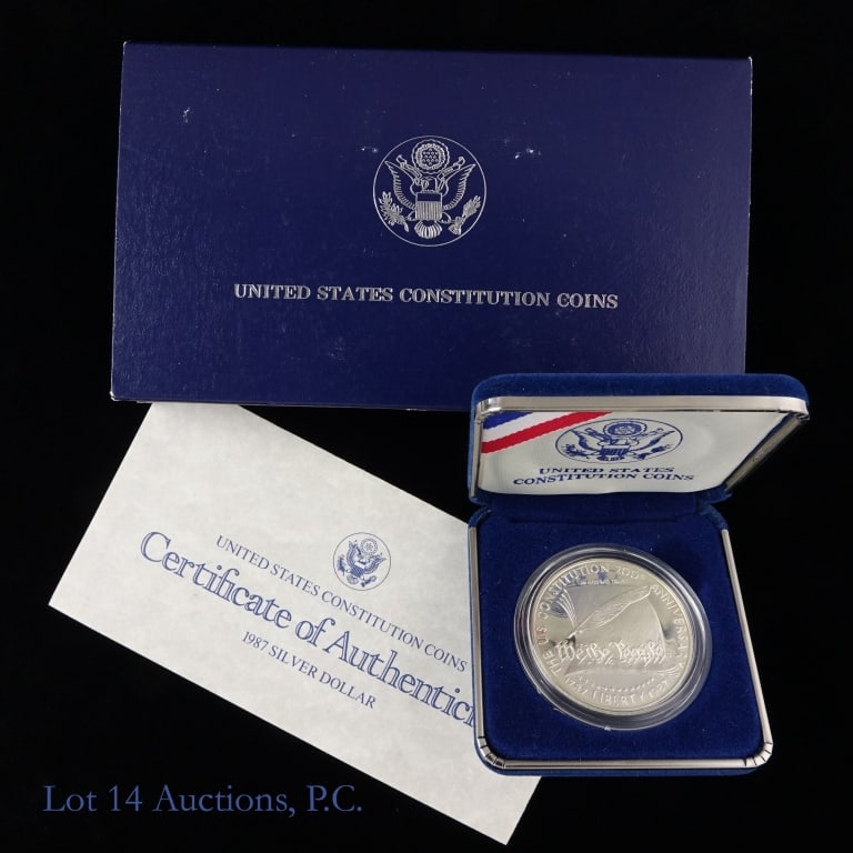 1987-S USA Silver Proof Constitution Com. $1 (OGP): 1987-S United States silver proof constitution commemorative dollar (San Francisco Mint) in OGP with COA. Designer Patricia Lewis Verani. Metal is 90% silver and weighs 26.73 grams. Mintage 2,747,116.