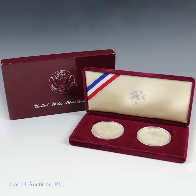 1983s & 1984s USA Silver Olympic $1 2-Coin Set: Two (2) United States silver proof Los Angeles Olympic Games dollars 2-coin set (San Francisco Mint) in OGP with COA and information booklet. Metal is 90% silver, weighs 26.73 grams, and diameter 38.1