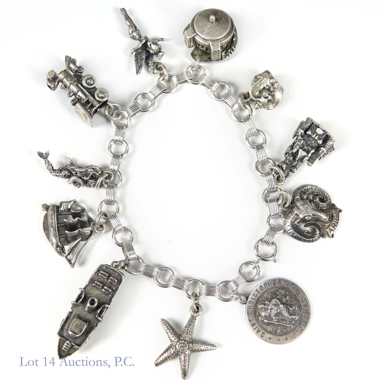 Sterling Silver Charm Bracelet: Charm bracelet. Clasp marked "sterling". Some of the 11 charms marked "sterling", including Tinkerbell which is also marked "W.D.P.", and Cinderella's castle which is marked "Disneyland sterling W.D.P