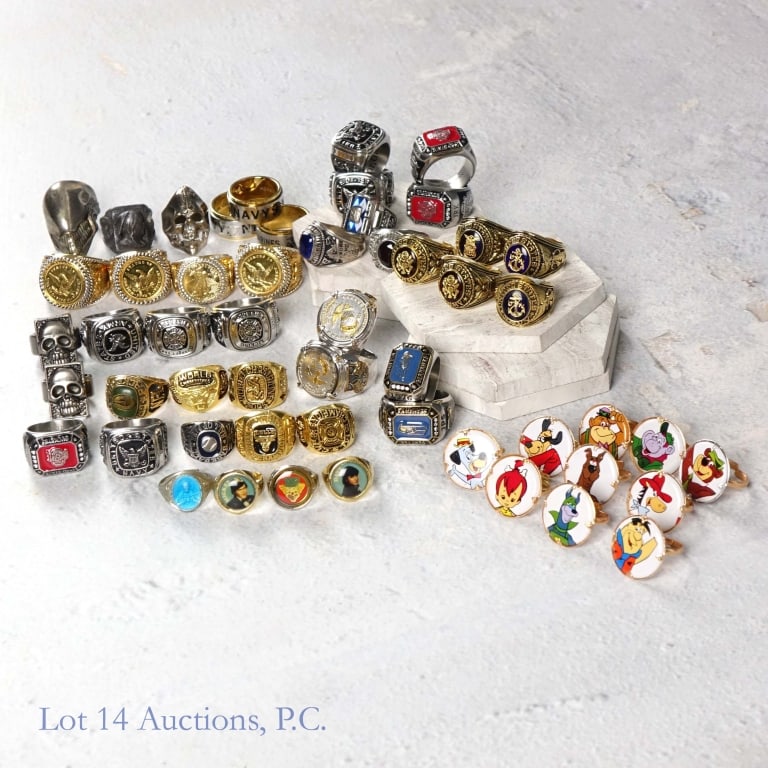 Novelty Rings, Sports, Military, Cartoons (53): 53 various novelty souvenir rings. Sizes between 7 and 15. Military, sports, cartoon themes. 6 of the rings depict an image of a coin. Weight approximately 2lbs 6oz including tray. See photos for deta