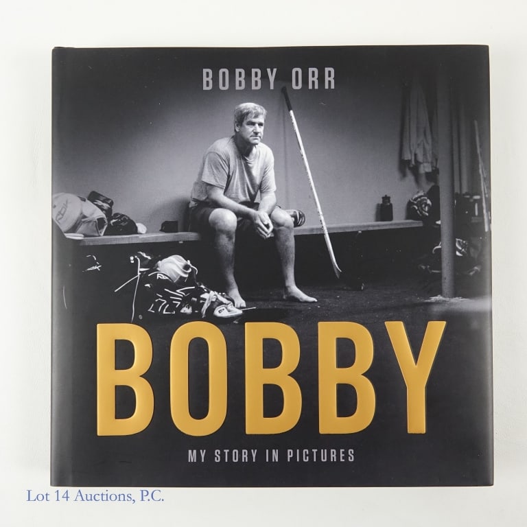 Signed Book "Bobby Orr My Story In Pictures": Hard cover book "Bobby: My Story In Pictures" signed by Bobby Orr. This book is an autobiography of Bobby Orr in both words and pictures. The book was signed by Bobby Orr with a black Sharpie. There i