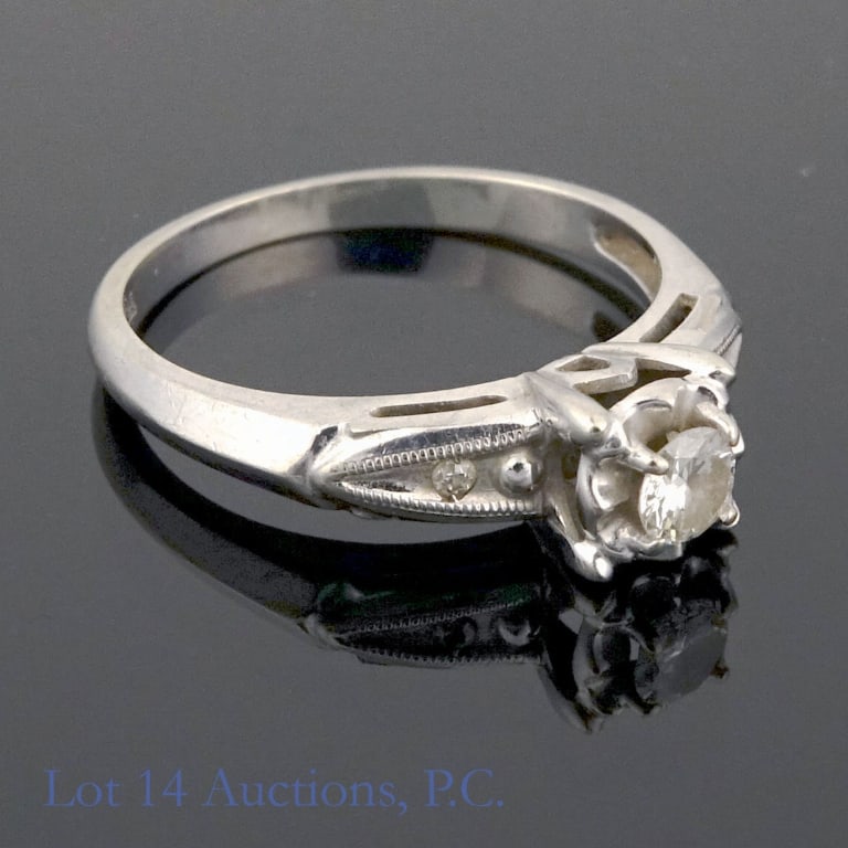 12K / 14K W Gold & Diamond Ring, Size 6: White gold ring marked "14k" with a maker's mark that resembles the letter "S" inside a letter "L". Electronically tests as 12 karat gold (which Lot 14 Auctions will stand behind). Central stone and t