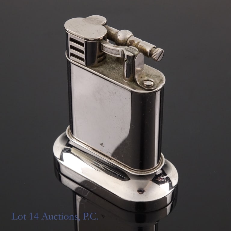 Dunhill Table Lighter: Dunhill Table Lighter in silver tone metal. Stamped "Dunhill Made in England 11403" at base. Measures approximately 2.5" x 2.25". Some scratches and signs of wear. See photos for details.