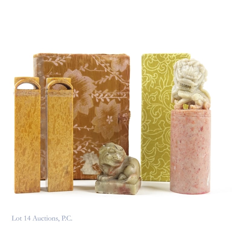 Four Vintage Chinese Stone Stamps: Four Chinese vintage seals or stamps. Two are decorated with lions on the top. Two match and come in a silk box, the top of which is held on with tape. The stamps show signs of age, and some are more 