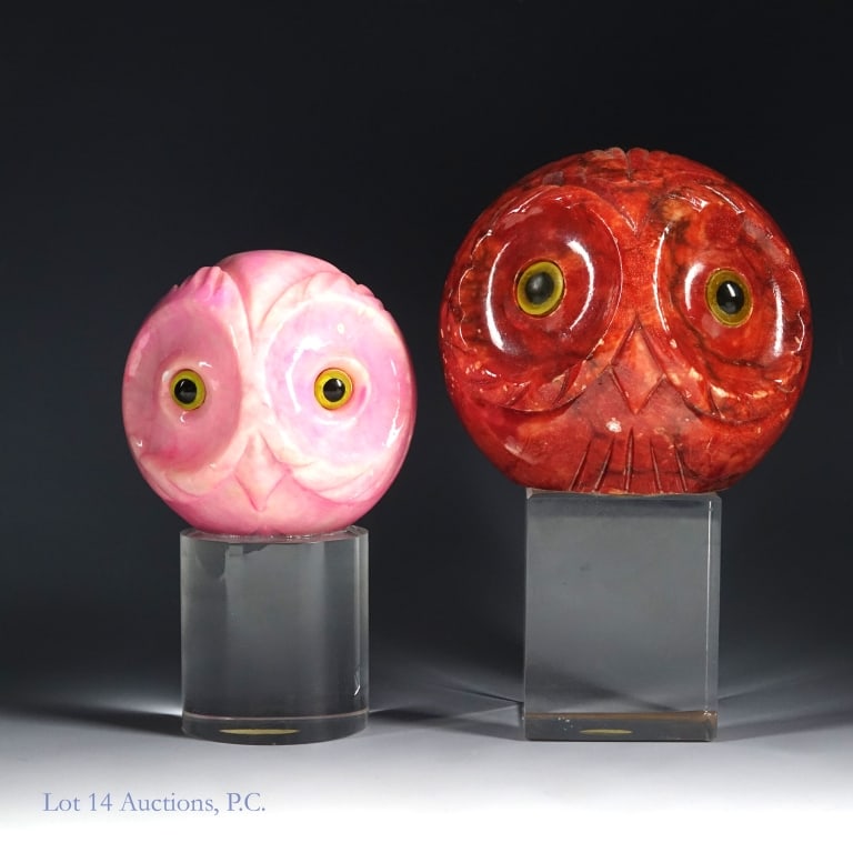 Two Italian Alabaster Owl Paperweights: Two vintage owl head paperweights carved from alabaster. Both have stickers reading "Made in Italy" on the underside. Both are attached to acrylic bases. The larger red one is approximately 6.25" tall