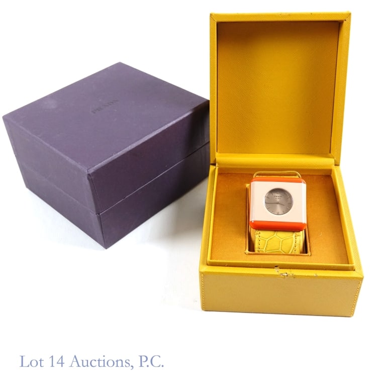 Prada Ladies' Watch Orange / Cyprus, New Cond.: Ladies' watch by Prada with box, presentation case, instructions and Authenticity certificate card. Referred to as the Prada square or Prada Plexi watch. Material is listed as "COCCO PLEX WRIS" and co