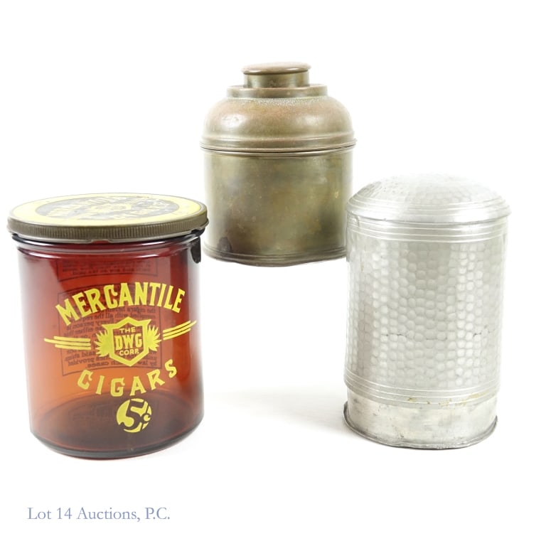 Advertising Cigar Jar & Metal Humidors (2): Empty Mercantile Cigars (5 cent) glass jar with lid. 5.5" tall. Approximately 4.75" diameter across lid. Weight: 1.6 pounds. Lid has some wear. ***** Rumidor brass humidor. 5-1/8" tall (with lid on).