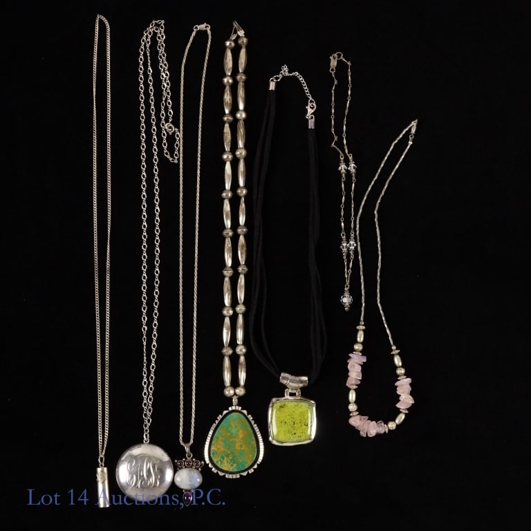 Sterling Silver Pendants, Necklaces, More: Seven pendants, necklaces, and lockets. Two are not marked: a mezuzah pendant necklace, and a chain with metal beads and rose quartz. Five are marked as sterling silver: a pendant with a green stone o