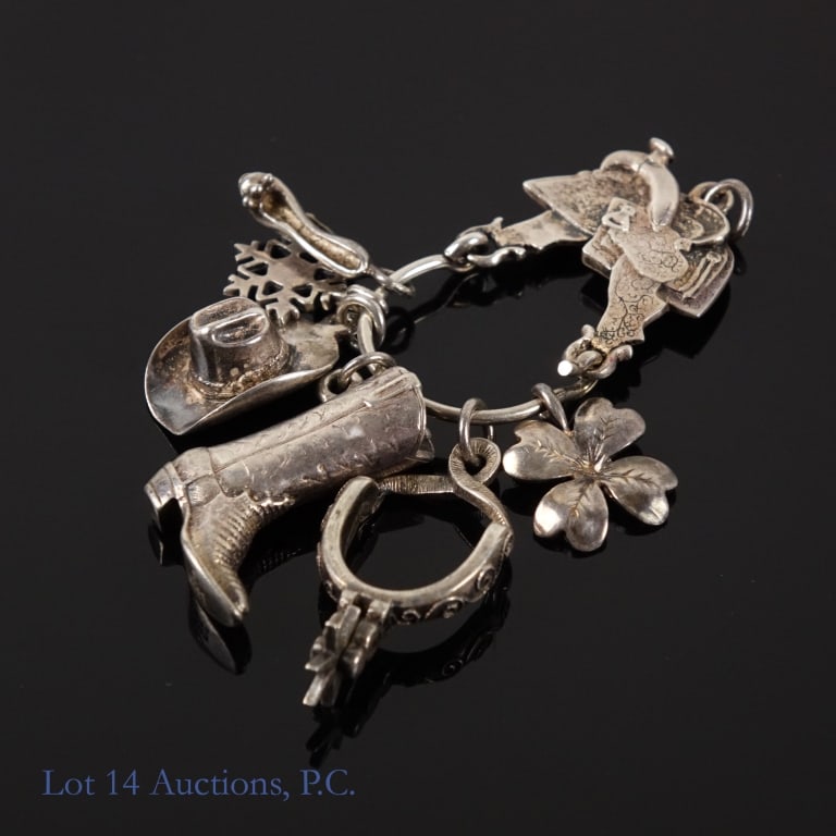 Sterling Silver James Avery Charms: Designer James Avery charm holder pendant & three charms, alongside three more non-James Avery sterling charms. The charm holder, shaped like a saddle, holds a cowboy hat, a cowboy boot, and a spur, a