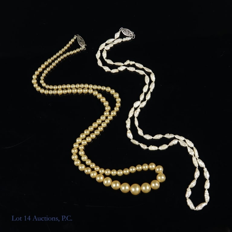 Two Pearl Necklaces 14k W Gold Clasps: Two pearl necklaces with 14k white gold box clasps. The first is a 19" strand of freshwater pearls and the other is a 20" strand of yellow pearls that get bigger closer to the center. Both in very goo
