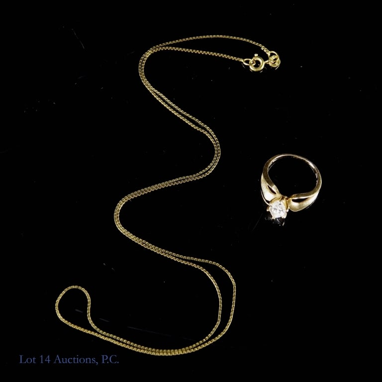 14K Yellow Gold Necklace And Ring: 14K gold necklace, approximately 20" long, and ring with cubic zirconia, size 5. Total weight 0.17ozt.