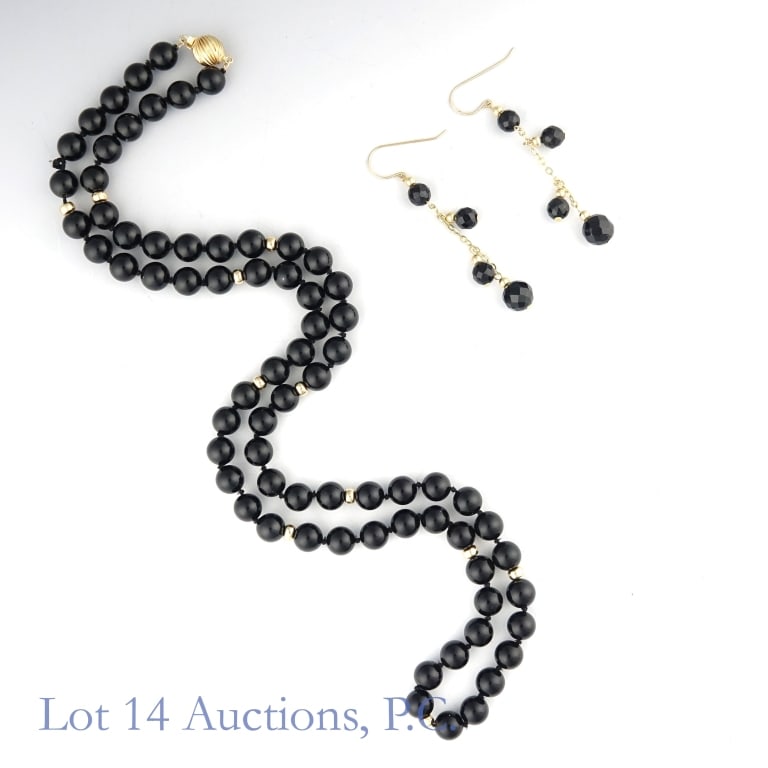 14k Gold Earrings & Necklace Set: Matching earrings and necklace set, all made with 14k yellow gold and onyx. The earrings have gold chains and hooks, and the necklace has a gold box clasp. The necklace appears to have one missing bea