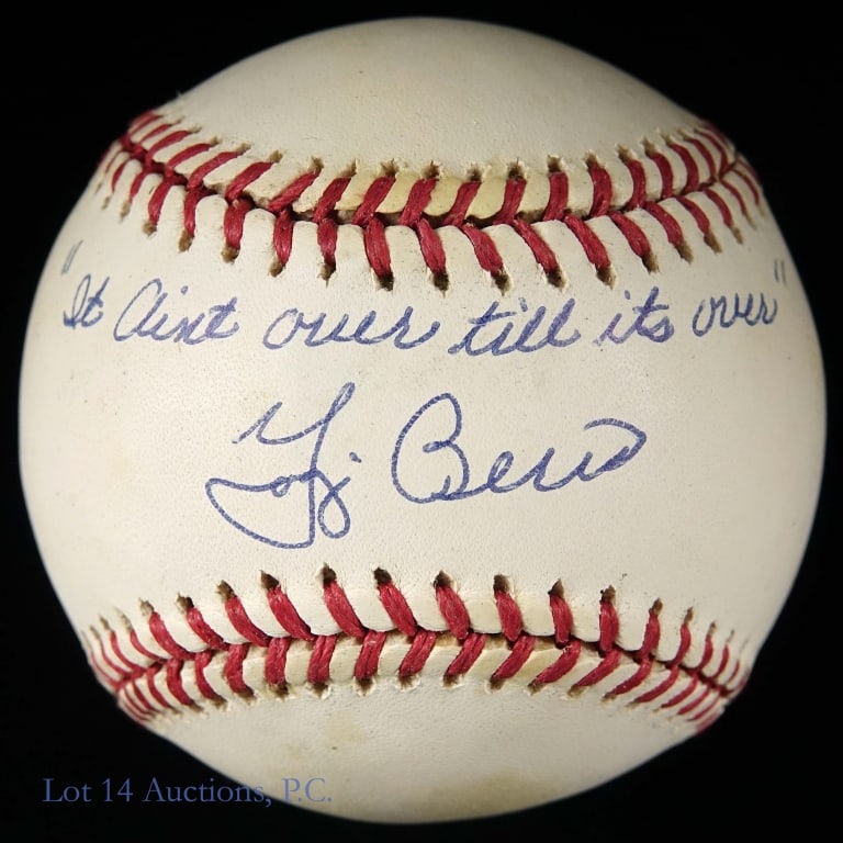 Yogi Berra Signed Baseball (It Ain't Over ...): Gene Budi OAL baseball signed on the sweet spot by Yogi Berra. Above the signature is the quote "It aint over till its over". There is NO COA (this lot is sold as is). Some spotting on the ball.