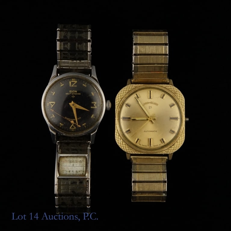 Lot of 2 Vintage Elgin Watches: Two watches from Elgin. The first is a self winding watch in the "Shockmaster" style with a black and gold art deco style dial. It also has a tiny calendar as part of the band. The second watch is a 1