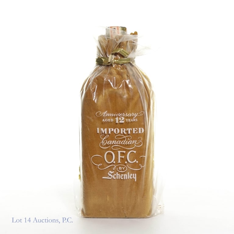 1946 O.F.C. By Schenley 12 Years Canadian Whiskey: 1946 O.F.C. By Schenley Aged 12 Years Anniversary Imported Canadian Whiskey. 96.8 Proof, 4/5 Quart. In original drawstring velvet bag inside the clear plastic bag with a logo secured with a wire tie.