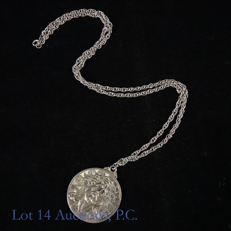 Sterling Silver Necklace & Coin Silver Medallion: Sterling silver necklace with a religious coin silver medallion pendant. Necklace is approximately 24" long. Pendant diameter is approximately 1.5". It features Jesus on one side and Virgin Mary on th
