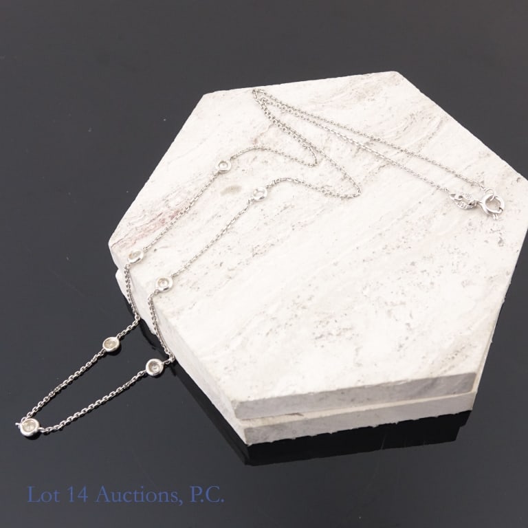 14k W Gold Necklace with Diamonds: 14k white gold chain with seven 1/16 ct diamonds set in. Total weight approximately 1.93g.