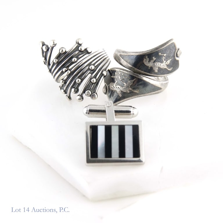 Sterling Silver Rings and Single Cufflink: Two vintage Sterling Silver rings. One is marked Siam Sterling with an adjustable niello style, the other marked Beau Sterling with an adjustable "firework" design. Also included in the lot is a