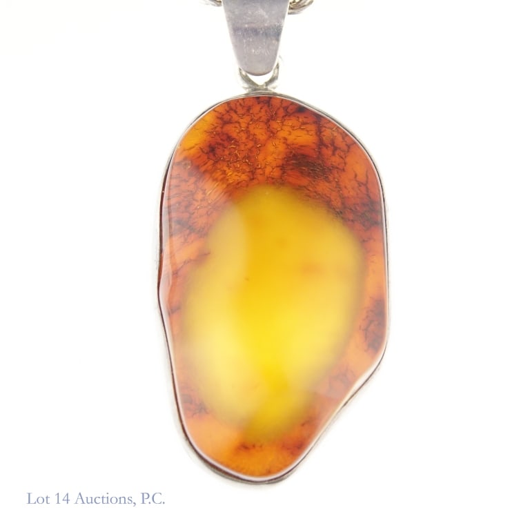 Baltic "Egg Yolk" Amber Sterling Silver Necklace: Sterling silver rope chain marked Italy with a large pendant made up of a chunk of Baltic / Egg Yolk amber set into sterling silver. Total weight of necklace approximately 100.68g.