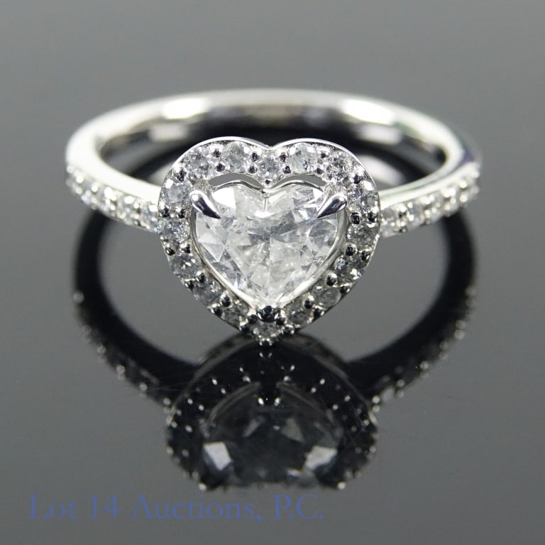 Platinum Diamond Ring w/ ID: Size 6 platinum ring decorated with diamonds (0.73 ct heart shaped center stone, 0.30 cttw side stones). Total weight of ring is approximately 3.9g. Identification and appraisal certificate from