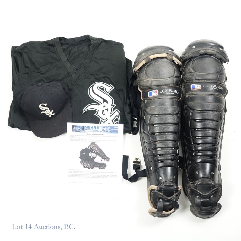 Game Worn White Sox Catchers Gear (Mears): Charles Johnson game worn catcher's collection - includes two LG21 W-PRO shin guards, Majestic batting practice jersey (size 44), and fitted New Era cap (size 7-1/8). The cap has an "8" written under