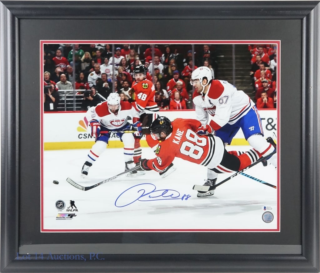Patrick Kane Signed 16"x20" Color Photo (Beckett): LOCAL PICK UP OR THIRD PARTY SHIPPING ONLY. 16"x 20" color photo of Patrick Kane diving for the puck in an NHL game between the Chicago Blackhawks and Montreal. Picture is signed in blue sharpie