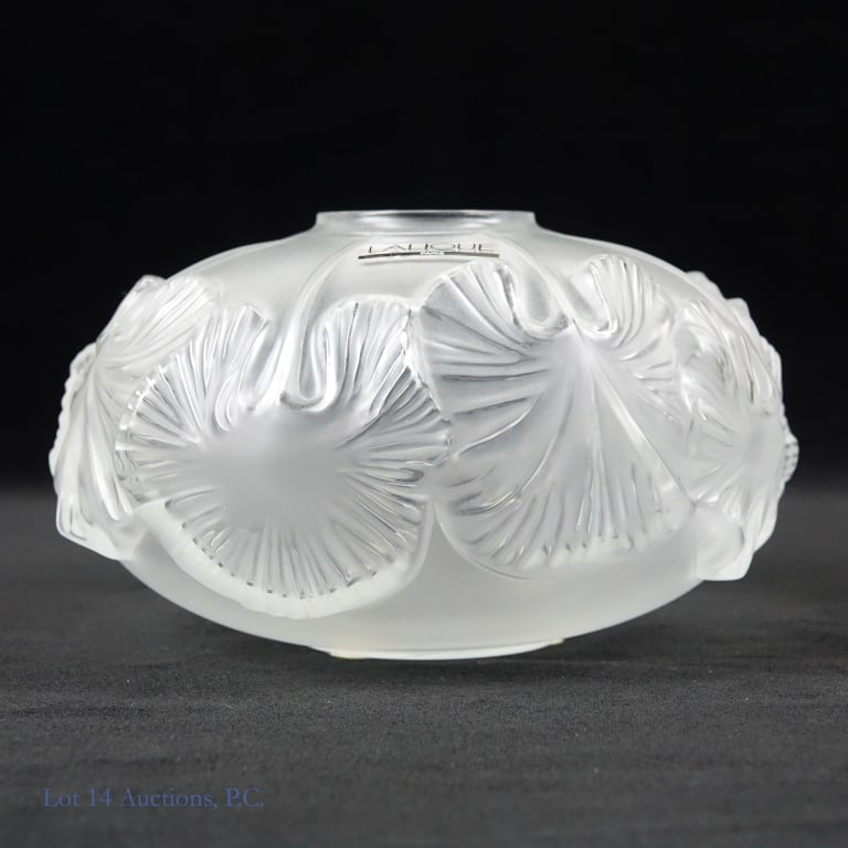 Lalique "Nympheas" / "Water Lilies" Vase: Crystal vase signed Lalique Paris with a design of overlapping lily pads. The design is called "Nympheas", or "Water Lilies" in English. Vase in very good condition, original sticker present. The