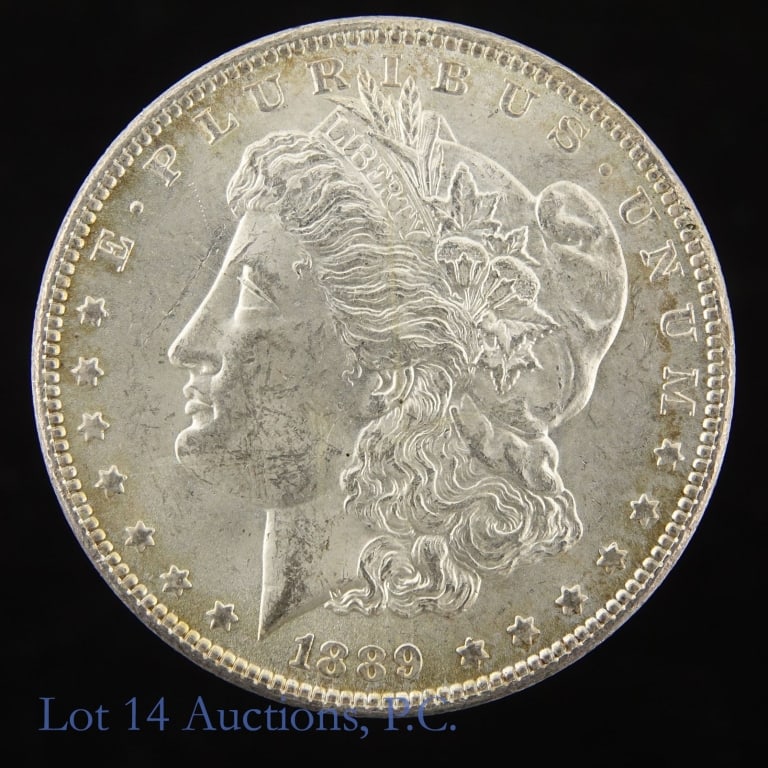 1889 (P) US Silver Morgan Dollar (*CH BU): 1889 (P) United States silver Morgan dollar (Philadelphia Mint). *Per consigner, in BU condition. Metal is 90% silver and weighs 26.73 grams. Silver content confirmed on Lot 14 Auctions