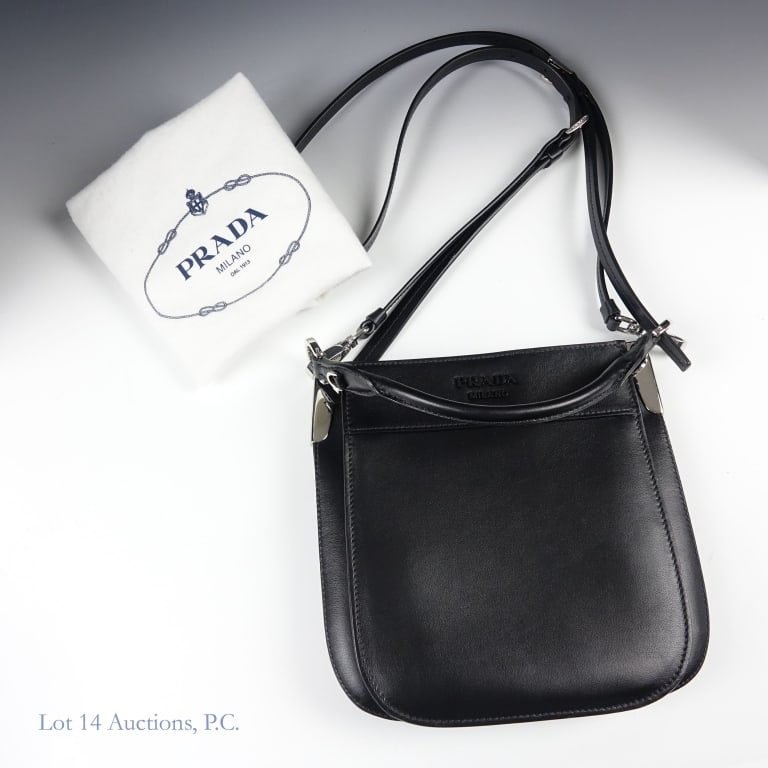 Prada Milano Margit Black Leather Hobo Bag: Prada Milano Margit Hobo Bag, done in all black leather with silver hardware. Comes with cloth dust bag. Good condition, little to no signs of wear. Measures approximately 8 x 1.5 x 7.75". Lot 14