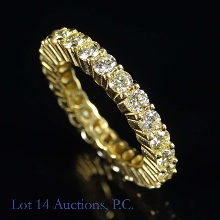 18k Yellow Gold Diamond Eternity Ring: Size 8.5 eternity ring made with 18k yellow gold, decorated with diamonds (3.00 cttw). Total weight of ring is approximately 8.05g. Identification and appraisal report from the Unified Gemological Ser