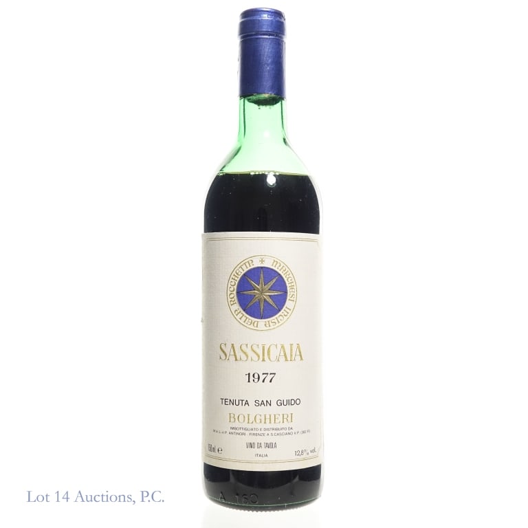1977 Tenuta San Guido Sassicaia Bolgheri: 1977 Tenuta San Guido Sassicaia Bolgheri, Tuscany, Italy. 750 ml, 12.8% ABV. Mid shoulder fill. Some damage to the rear label. Consigned by the estate of a collector who stored wine and champagne bott