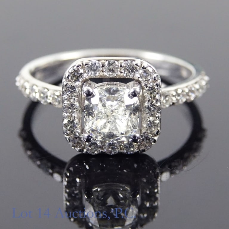 14k W Gold Diamond Ring: Size 6.5 engagement ring made with 14k white gold, decorated with diamonds (1.01 ct center stone and 0.50 cttw side stones). Total weight of ring is approximately 2.85g. Identification and appraisal r