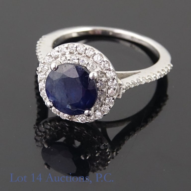 14k White Gold Sapphire & Diamond Ring: Size 6 engagement style ring made with 14k white gold, decorated with a large blue sapphire surrounded by diamonds (2.00 ct sapphire, a little under 0.42 cttw diamonds). One diamond is missing from