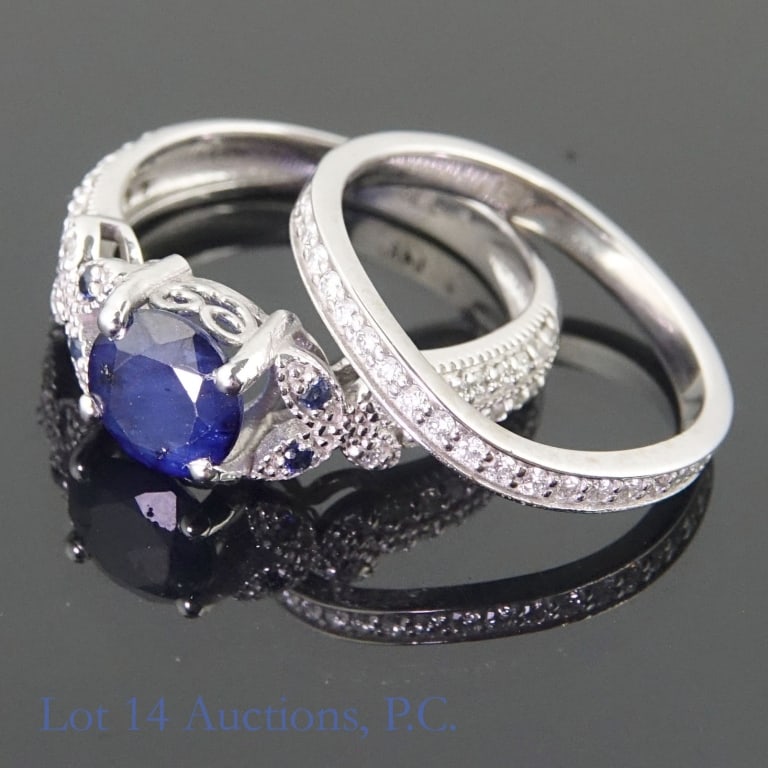 14k White Gold Sapphire & Diamond Bridal Ring Set: Set of two size 6.5 classic bridal style ring set made with 14k white gold, decorated with one large sapphire and four small sapphires alongside many small diamonds (1.00 ct large sapphire, 0.10 cttw