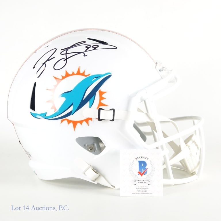 Jason Taylor Sig FS Mia Dolphins Helmet (Beckett): Riddell full sized replica Miami Dolphins helmet. Signed on the right side in black sharpie by Jason Taylor (inscribed "99"). Beckett witnessed sticker on back of helmet (WL08185). We have verified th