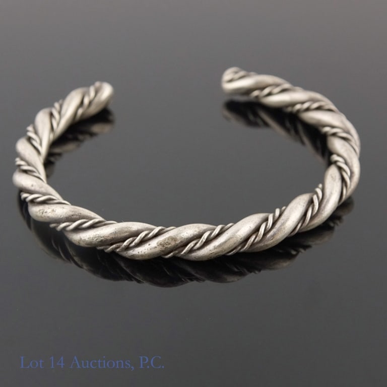 Sterling Silver Twisted Style Bangle Bracelet 1ozt: Solid twisted style sterling silver bangle bracelet. 2.15" interior diameter at widest point. 33g (1.1 ozt.).