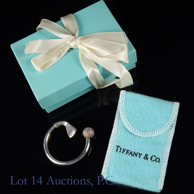 Tiffany & Co. Sterling Silver Golf Club Keyring: Tiffany & Co. sterling silver golf club and golf ball keyring. Never used. In original Tiffany bag and box, with ribbon. Lot 14 guarantees the authenticity of this keyring.