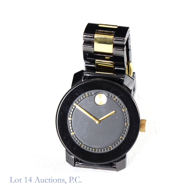 Movado Bold Wrist Watch In Original Box: Movado Bold wrist watch. 36mm black case with black and gold tone bracelet. Black dial with gold tone hands, markers and signature 12 o'clock sundial dot. Needs battery. In original box.