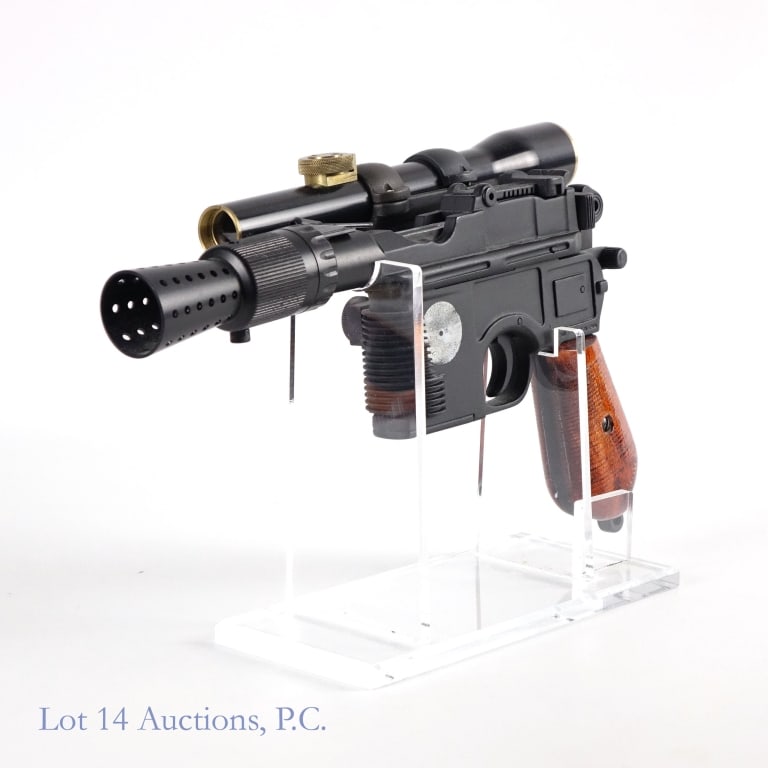 Star Wars Han Solo DL-44 Blaster Prop Replica: Star Wars Han Solo DL-44 Blaster prop replica. As seen in The Force Awakens from the original Star Wars Trilogy. Heavy replica made entirely of metal with a wooden handle and an acrylic stand.