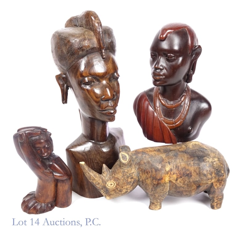 African Wooden Statues (Tanzania, Kenya, More): Four wooden statues originating in Africa. The first is a larger bust measuring approximately 5 x 6 x 13, labeled "Tanzania 1971" on the underside. The second is a smaller bust measuring