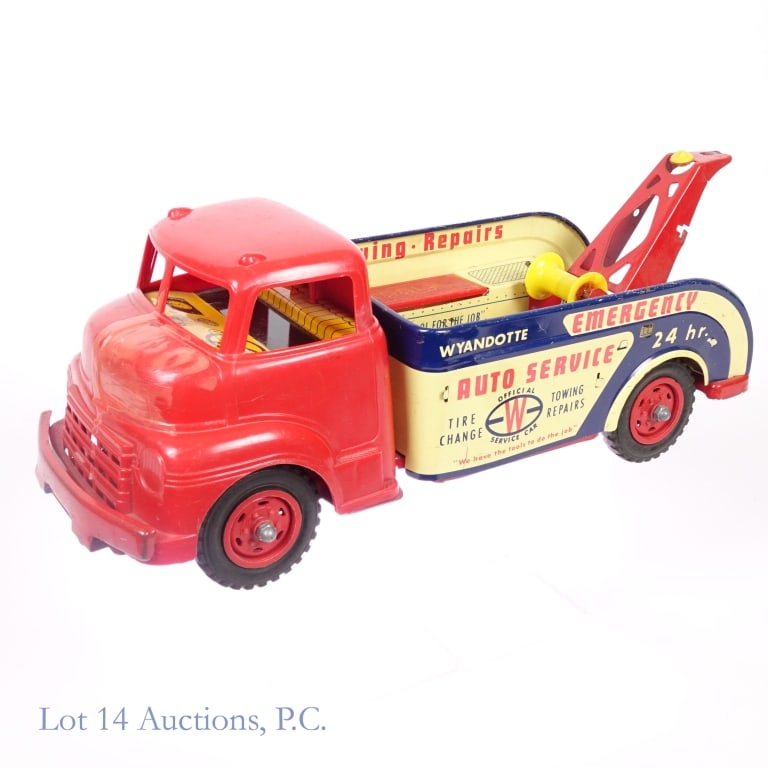 Wyandotte 24 Hr. Emergency Auto Service Tow Truck: 1950s Wyandotte tin litho "24 Hr. Emergency Auto Service" tow truck. Pressed steel body, plastic cabin. Includes spare wheel. Tools, jack and towing chain not included. Approximately 15" X 5" X 6".