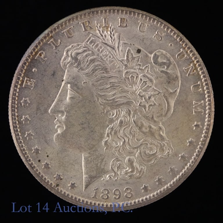 1898-O US Silver Morgan Dollar: 1898-O United States silver Morgan dollar (New Orleans Mint). *Per consigner, has clean cheek and original surfaces in BU condition. Metal is 90% silver with ASW 0.7734 troy ounces. Mintage 4,440,000.